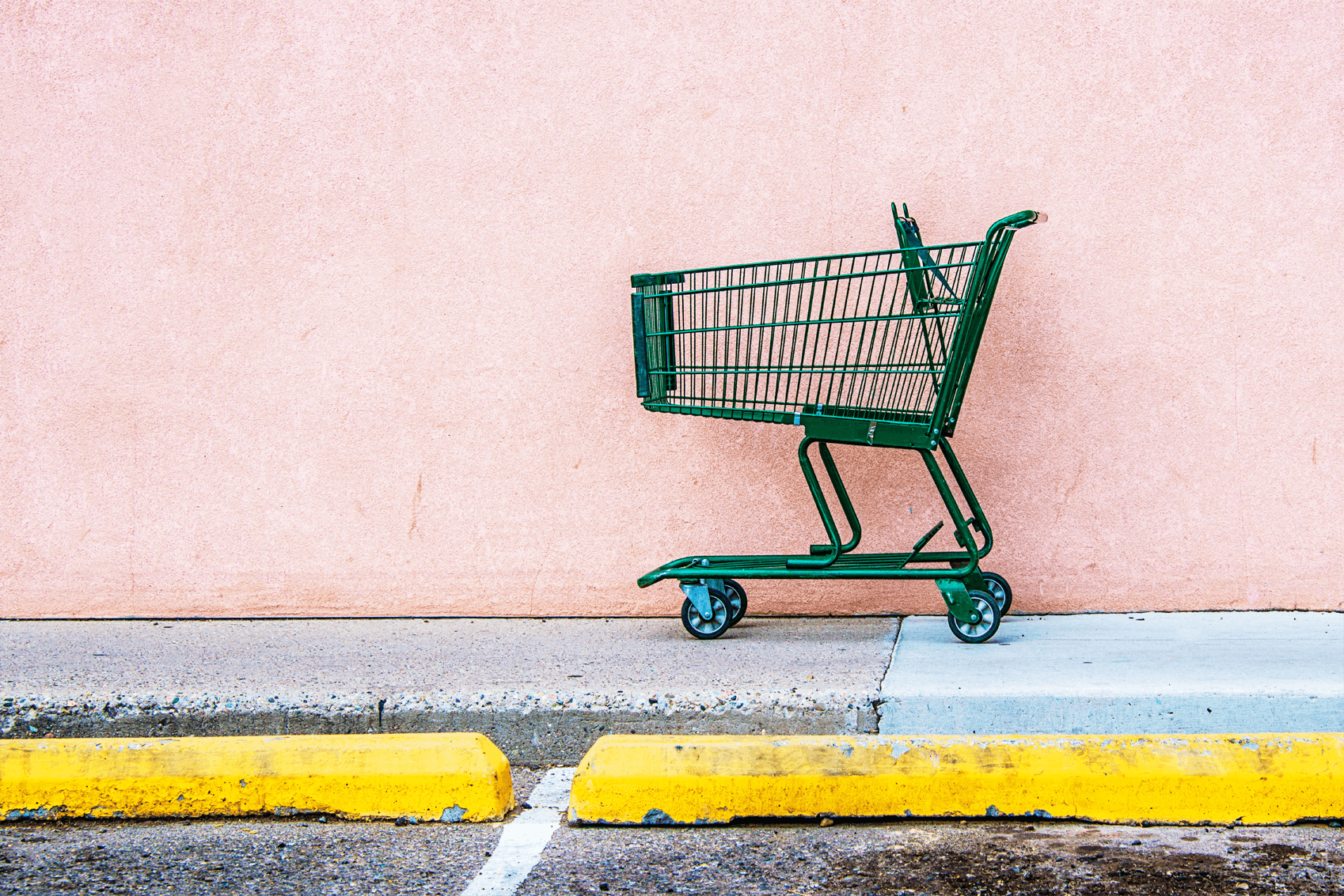 Shopping trolley behind a yellow curb